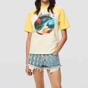 yellow and white retro t-shirt with a graphic landscape print by loewe paulas ibiza and raw edge denim shorts